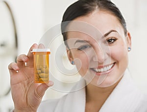 Woman Holding up Medication