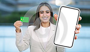 Woman Holding Up Smart Phone and Credit Card