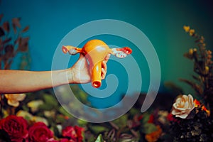 Woman Holding a Uterus Model on a Floral Background