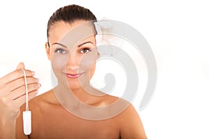 Woman holding vaginal tampon photo