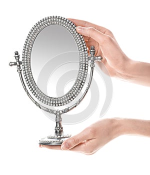 Woman holding vintage mirror