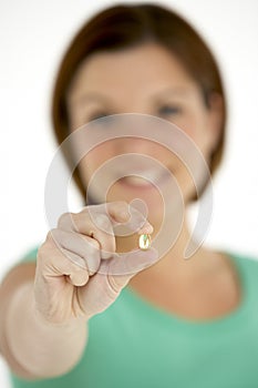 Woman Holding Vitamin Capsule