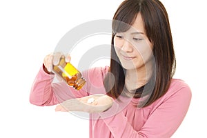 Woman holding vitamin pills