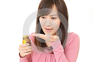 Woman holding vitamin pills