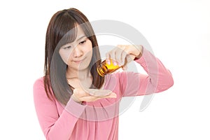 Woman holding vitamin pills