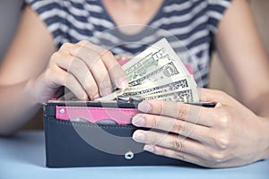 Woman holding wallet with money