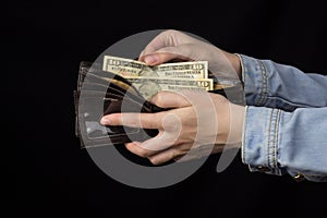 Woman holding a wallet with money, close-up, Black background, banknote, dollars