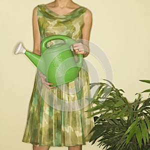 Woman holding watering can.