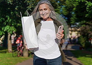 Woman Holding White Bag and Cell Phone