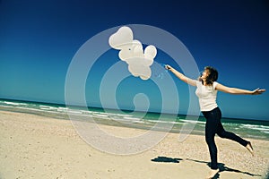 Woman holding white balloons