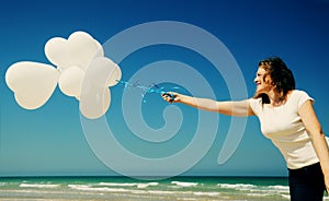 Woman holding white balloons