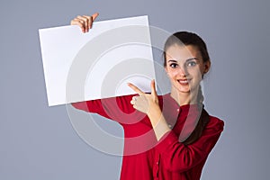 Woman holding white sheet of paper