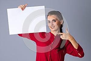 Woman holding white sheet of paper