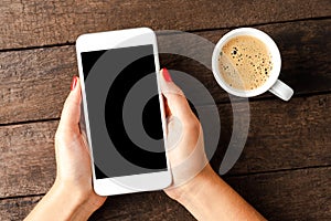 Woman holding white smart phone with copyspace