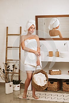 Woman holding wicker basket with laundry