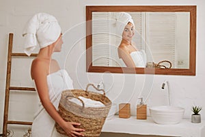 Woman holding wicker basket with laundry