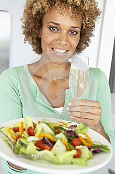 Woman Holding A Wine Glass And Fresh Salad