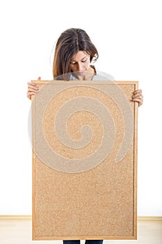 Woman holding a wooden board cork isolated on white background a