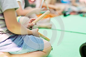 Woman holding wooden musical sticks photo