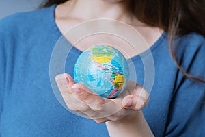 Woman holding world globe in her hands