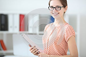 woman holding a writing tablet in the office