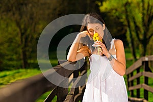 Woman holding yellow flowers