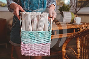 Woman holds basket with sets for basketmaker