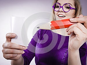Woman holds big pencil note paper in hand