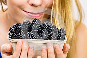 Woman holds blackberry fruits