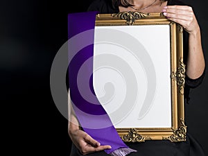 Woman holds blank mourning frame with sympathy flower