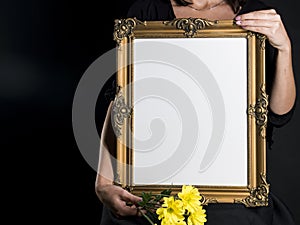 Woman holds blank mourning frame with sympathy flower