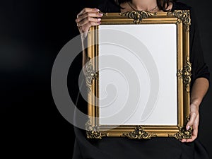 Woman holds blank mourning frame with sympathy flower