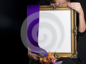 Woman holds blank mourning frame with sympathy flower