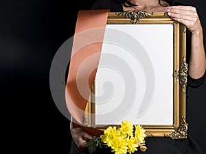 Woman holds blank mourning frame with sympathy flower
