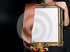 Woman holds blank mourning frame with sympathy flower