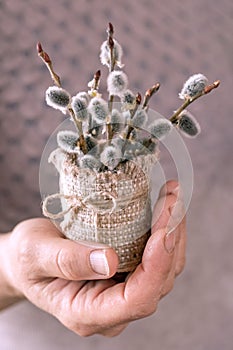 Woman holds a bouquet of flowering willow branches