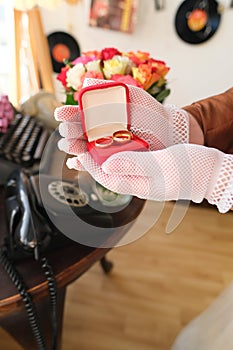 Woman holds box with red box with jewelry, opens it, concept of holiday, anniversary of married couple, valentine`s day