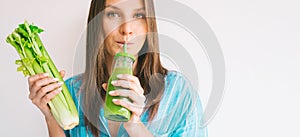 Woman holds bunch of fresh celery stalk and drinks fresh homemade celery juice