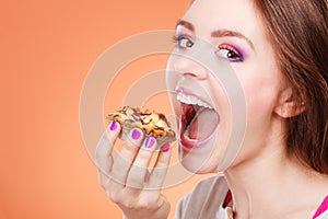 Woman holds cake in hand closeup