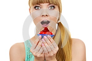 Woman holds cake strawberry cupcake