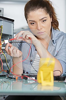 woman holds device that measures pc cables voltage