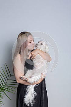 A woman holds a dog in her arms 2