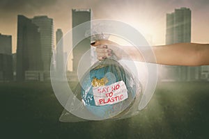 Woman holds an earth globe in plastic bag