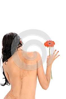 Woman holds flower, from back