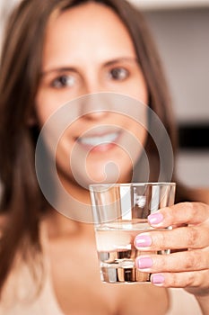 Woman holds a glass of water