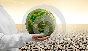 Woman holds a green planet Earth