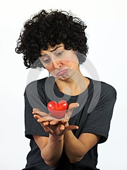 Woman holds heart in her hands