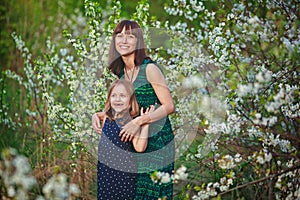 A woman holds her daughter in her arms