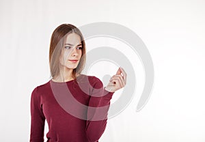 Woman holds in her hand an imaginary credit card