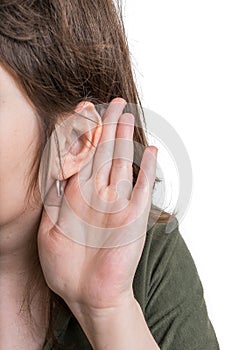 Woman holds her hand near ear and listening carefully